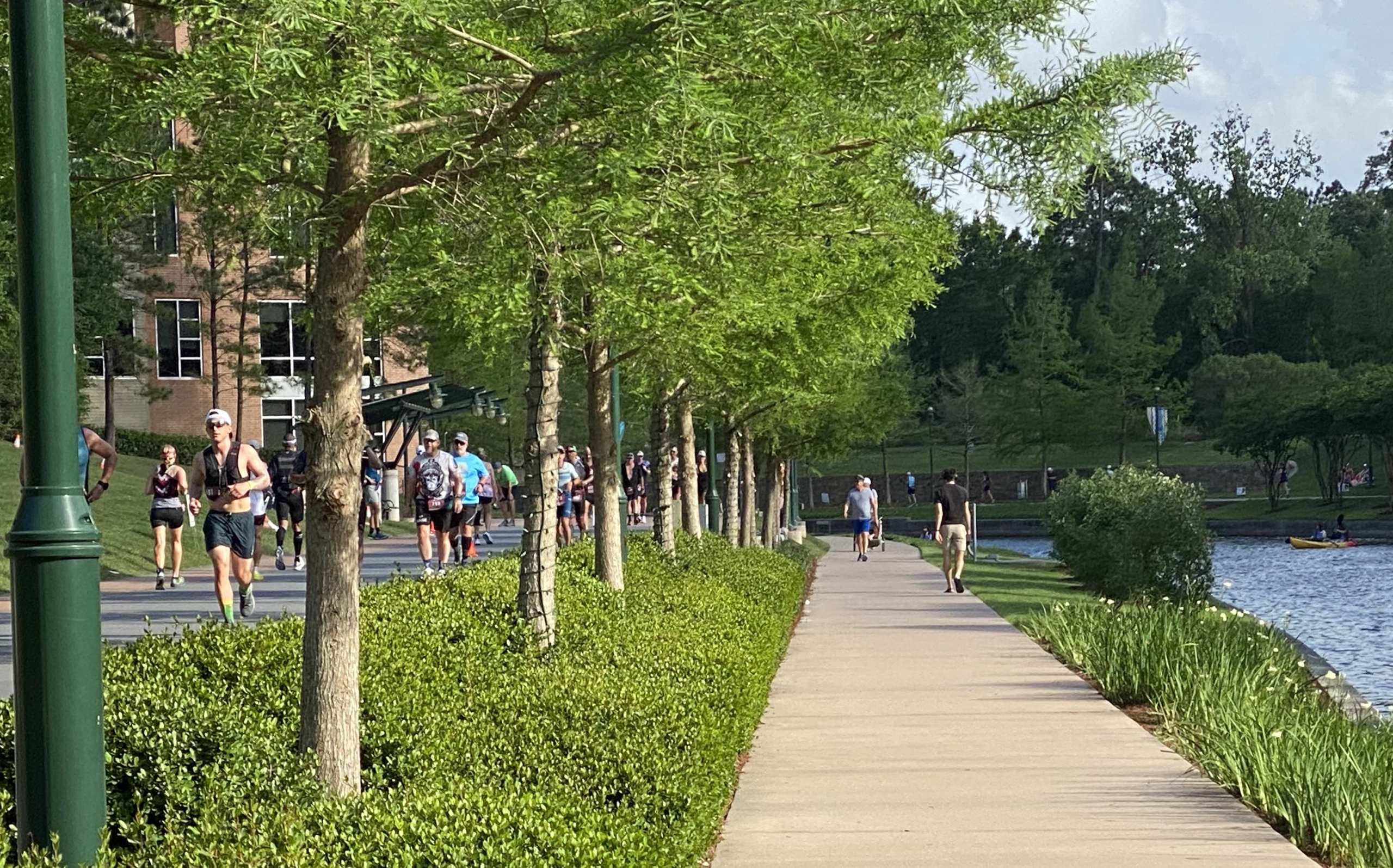 Athletes on high road, pedestrians along lower road.