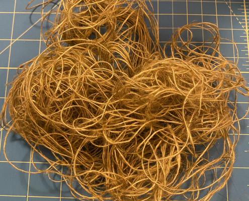 Tangled skein of dark gold linen thread