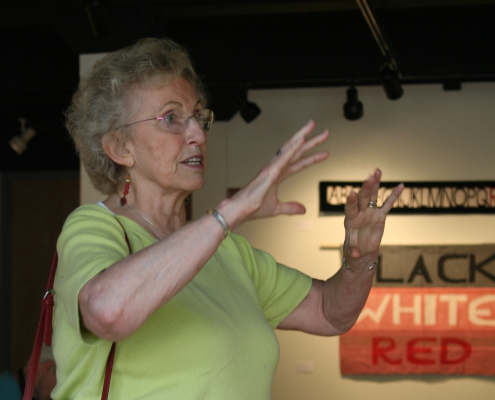 Beth Beede with her hands raised, describing something.