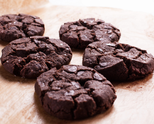Chocolate chocolate chip cookies on a wooden surface